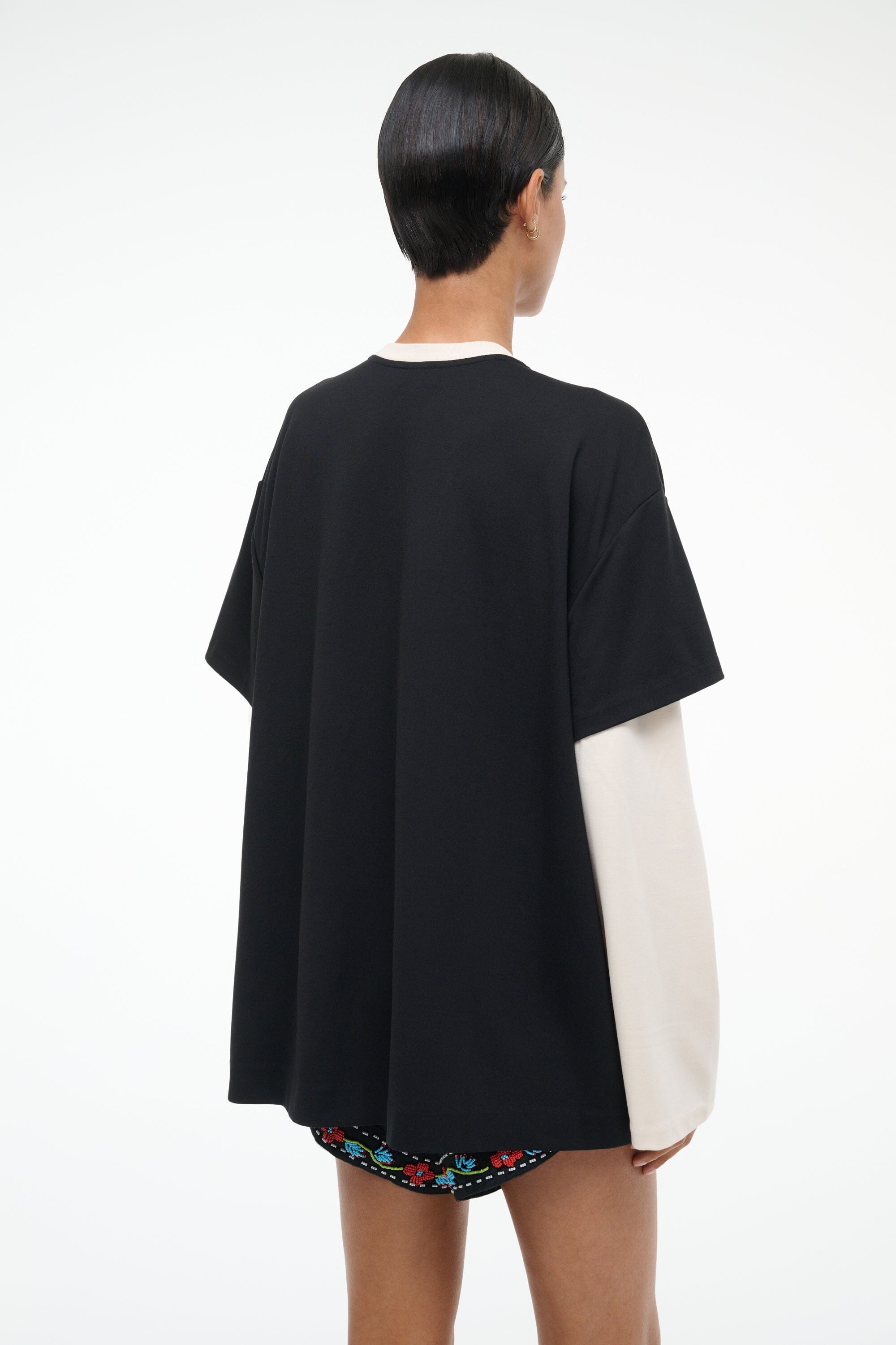 Black T-shirt with contrasting ecru side drape and white crew neckline trim