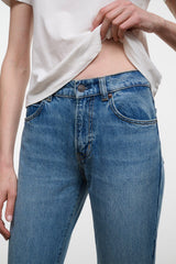 Blue flare jeans front close-up with waistband, fly, and side pockets