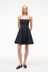 Black mini dress with spaghetti straps, fitted bodice and flared skirt