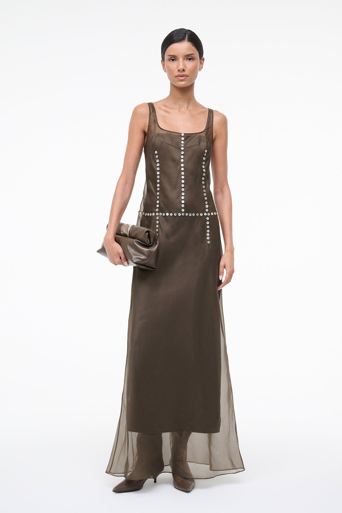Dark taupe cuff clutch held in model’s hand, silver clasp and zipper top