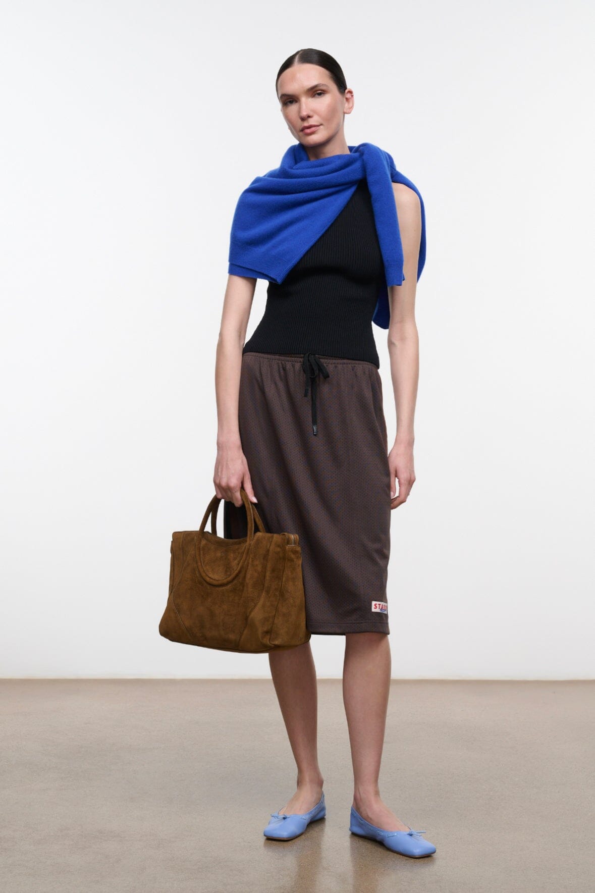 Dark brown midi skirt with drawstring waist and hem logo patch, relaxed fit
