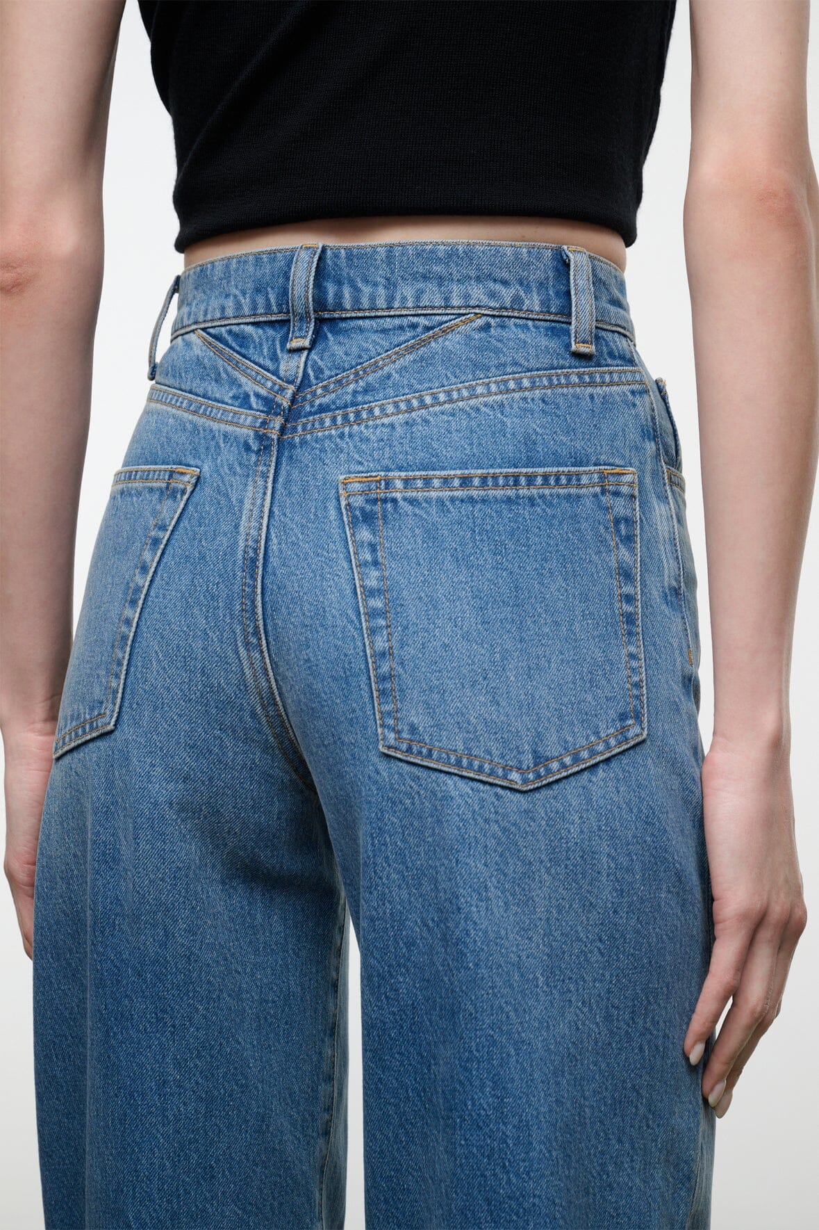 Blue denim jeans with back yoke, belt loops, and two rear patch pockets