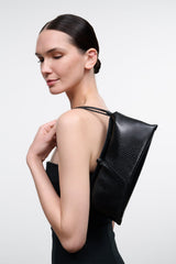 Back view of black snakeskin-textured clutch with top opening and strap