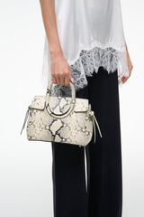 Mini carryall handbag with white snake-embossed pattern and top handle