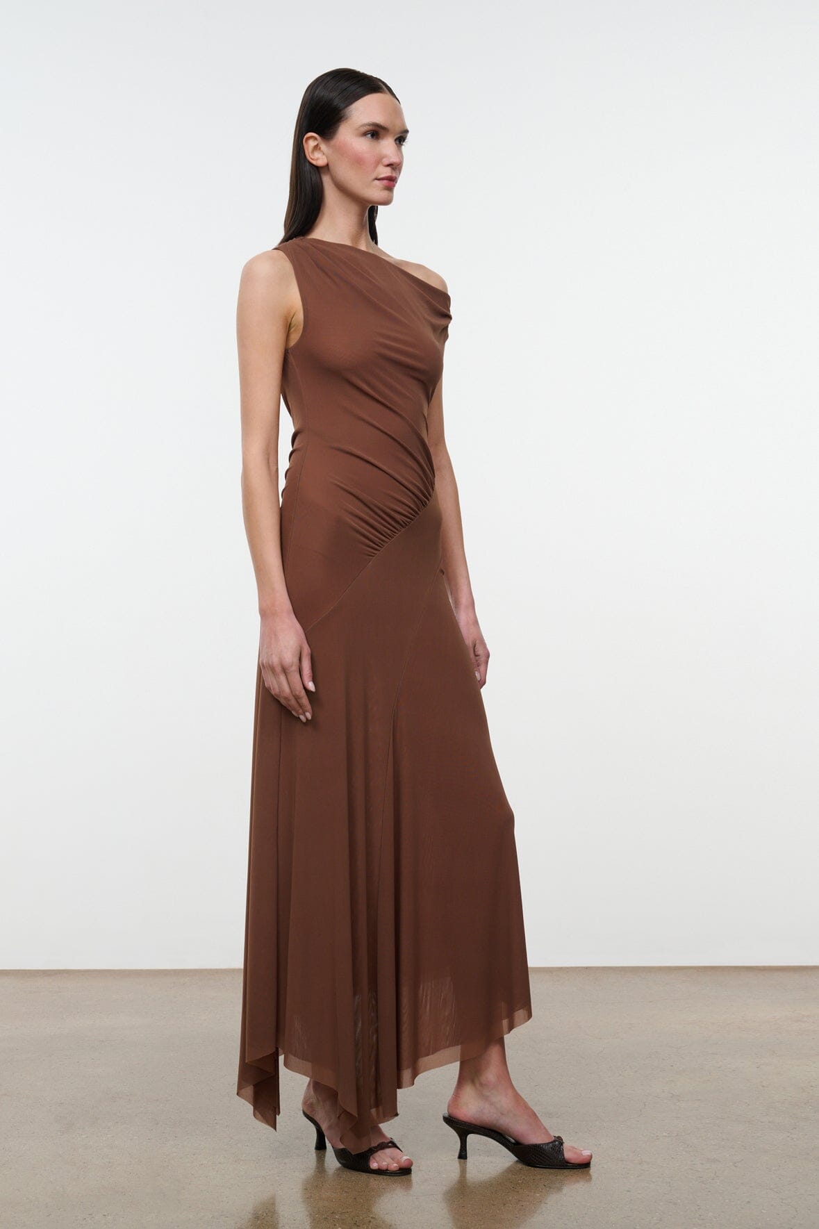 Brown one-shoulder ruched maxi dress with side drape and flowing asym hem