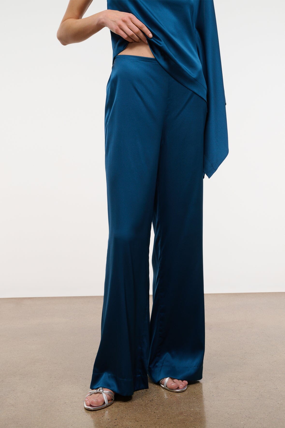 Blue silk wide-leg pant showing full front with relaxed flared legs