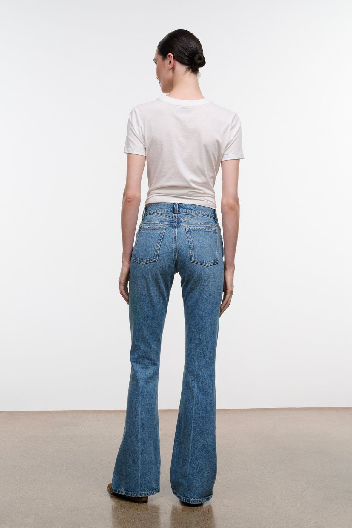Blue flare jeans back view with rear yoke and patch pockets