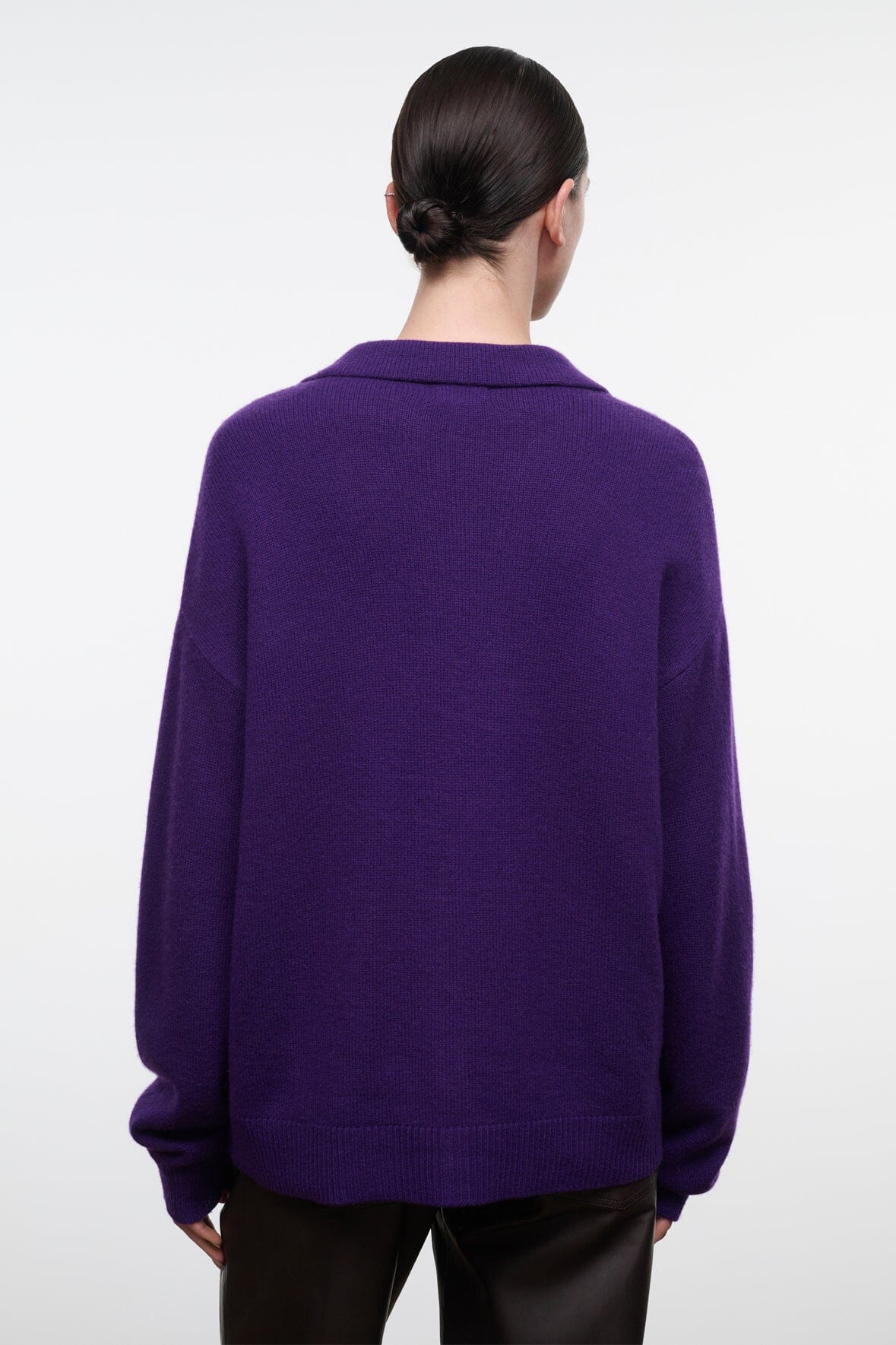Back view of purple cashmere cardigan with button placket and ribbed hem