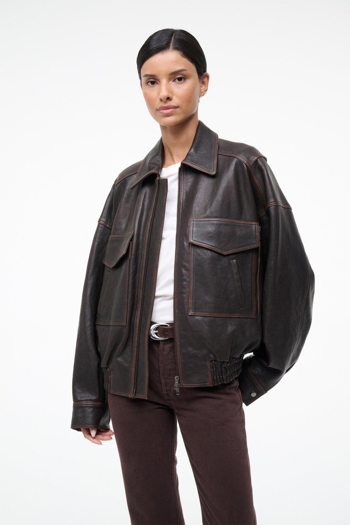 Distressed brown leather jacket with stand collar, zip front, and two flap pockets