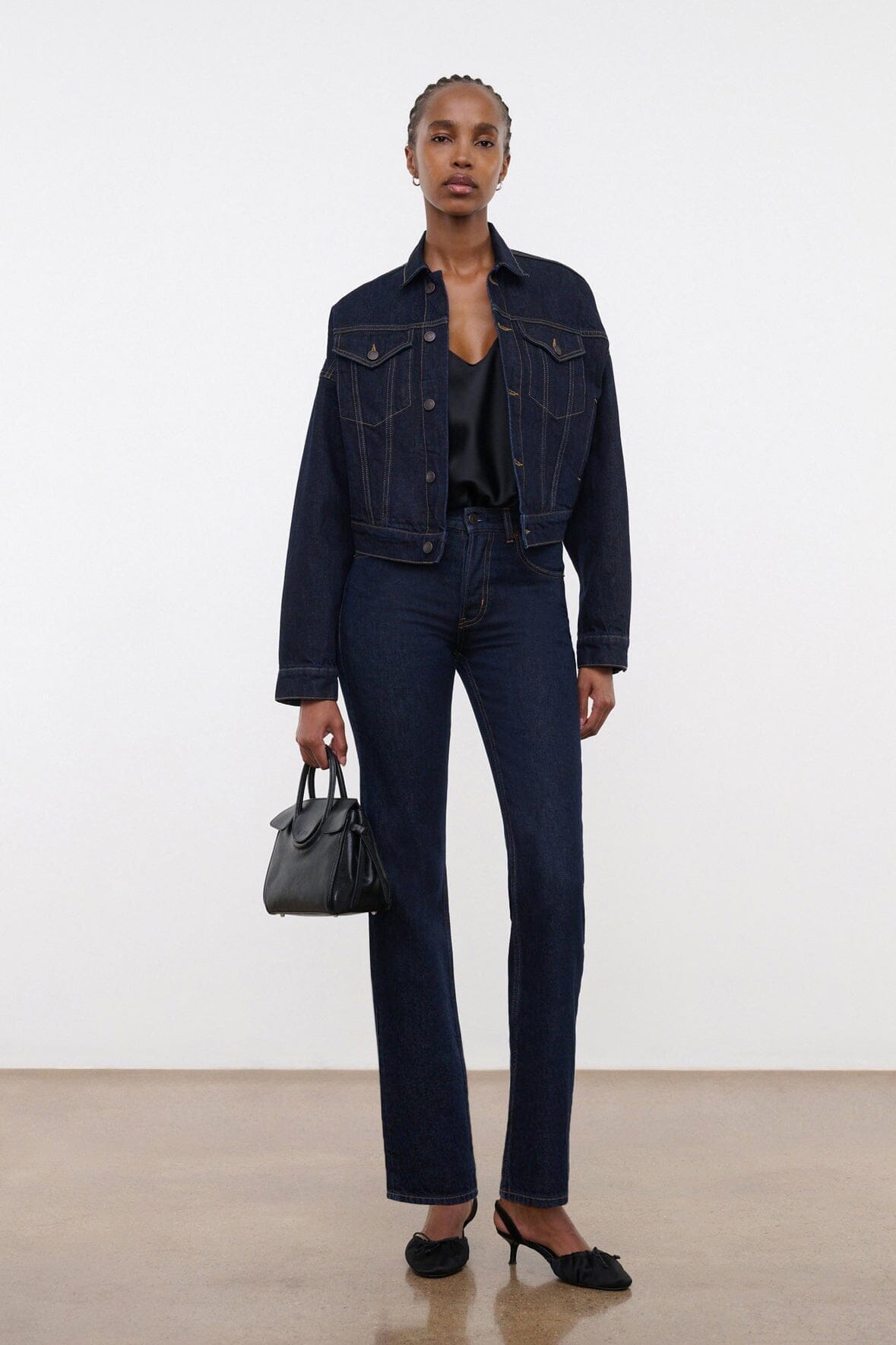 Indigo denim jacket worn with dark jeans, long sleeves and buttoned flap pockets