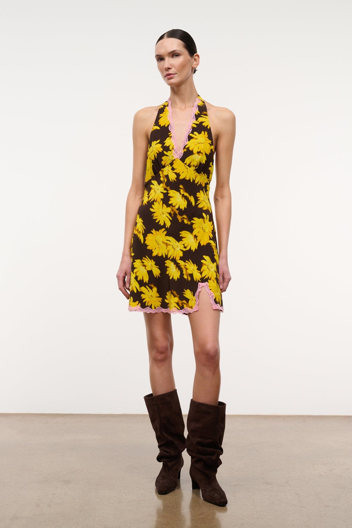Yellow daisy print halter mini dress with V neckline and pink lace trim