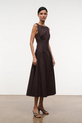 Brown sleeveless midi dress with ruched waist and swing skirt, side view.