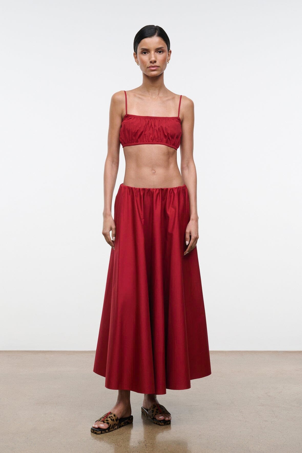 Red midi skirt with gathered waistband and flowy pleated skirt