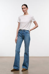 Blue flare jeans with front pockets, light wash, and stitched seams