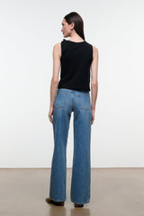 Back view of blue denim jeans with wide legs, belt loops, and rear yoke seaming