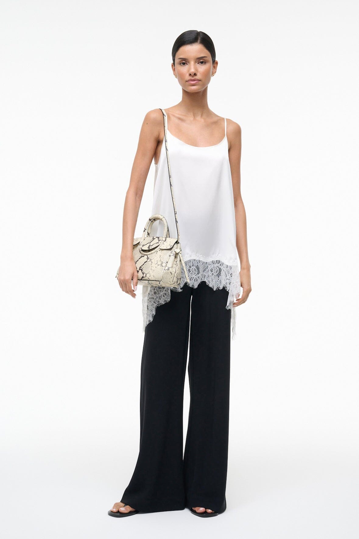 Mini carryall handbag in white snake-embossed print with buckle front and shoulder strap