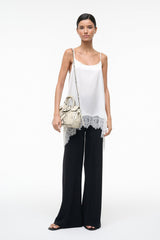 Mini carryall handbag in white snake-embossed print with buckle front and shoulder strap