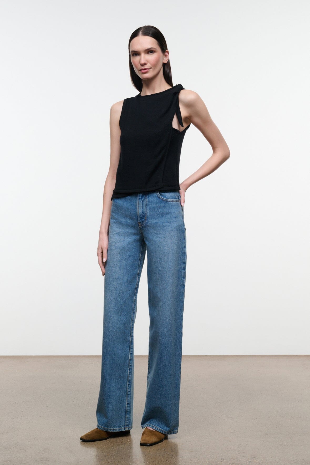 Blue denim jeans with wide straight legs, belt loops, front pockets, clean hem