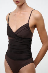 Dark brown ruched one-piece swimsuit with spaghetti straps and V-shaped wrap neckline