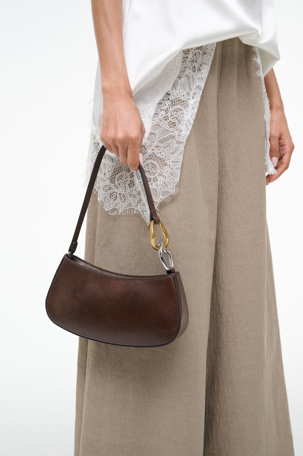 Espresso-brown Ollie hobo bag with gold ring handle, carried at the side