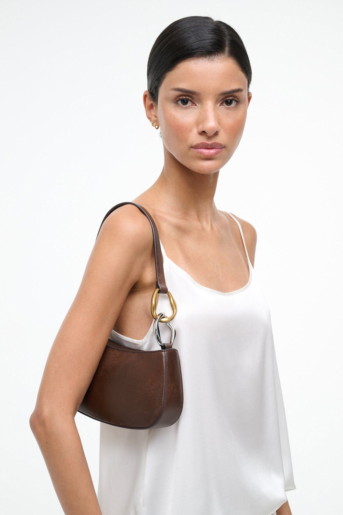 Ollie espresso-brown hobo bag with gold ring handle, worn on the shoulder