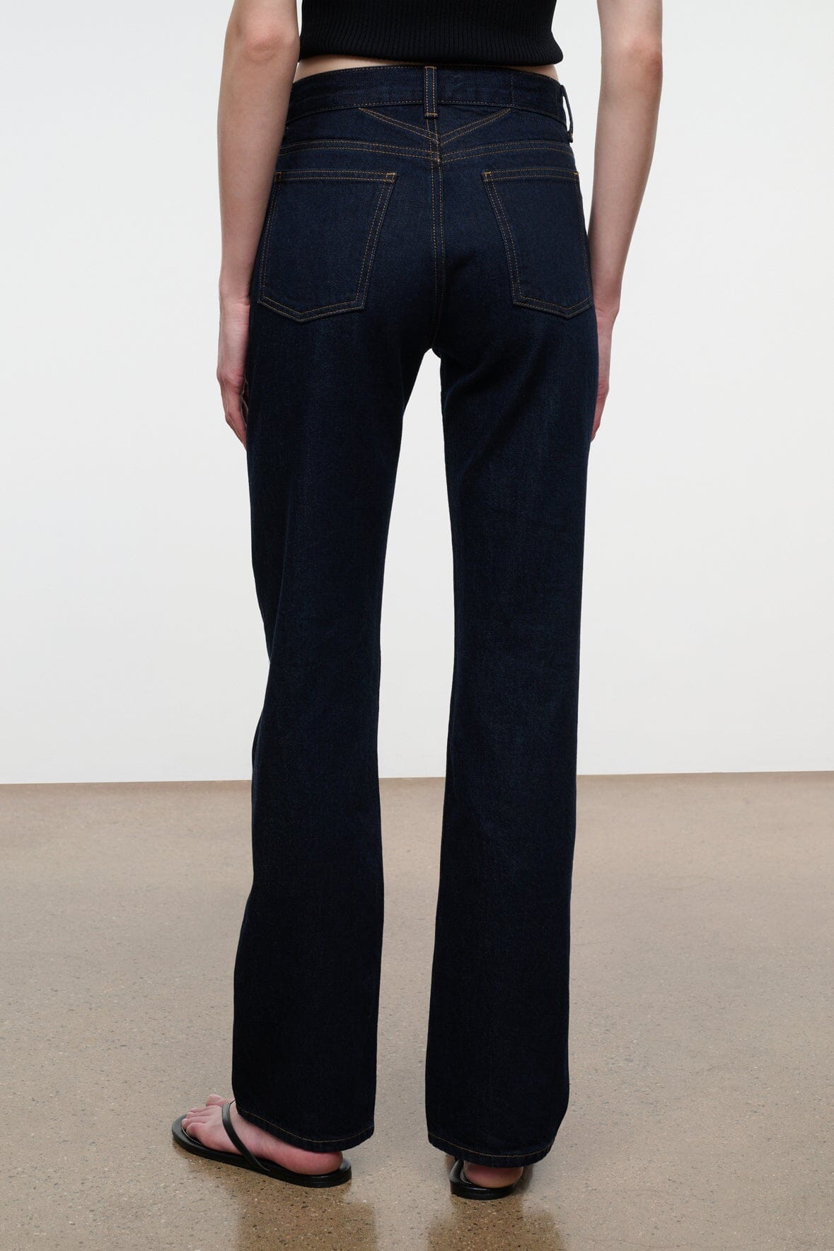 Indigo straight jeans with back pockets, yoke seam, and contrast topstitching