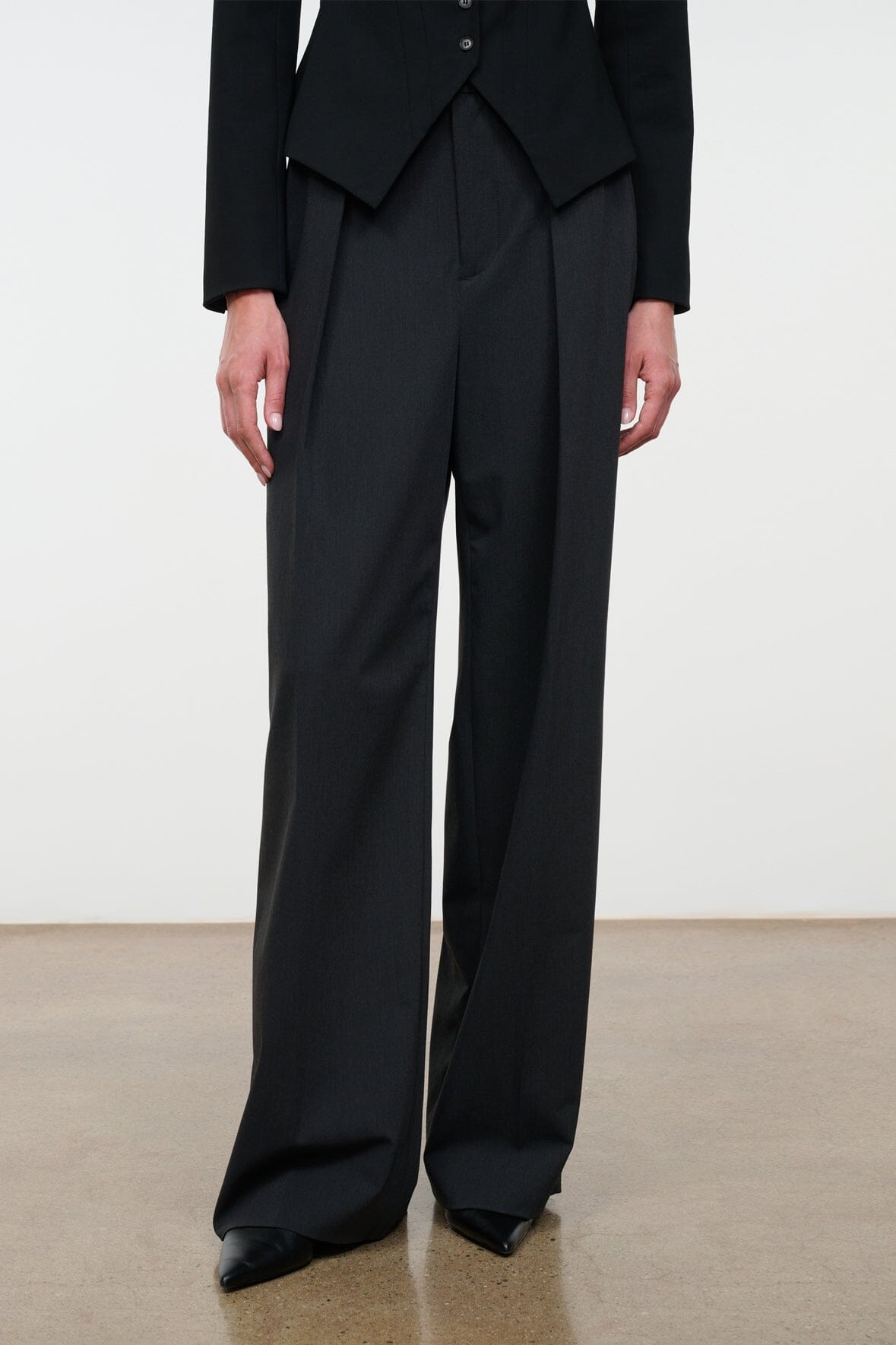Tailored wide-leg trousers with front crease and full-length drape