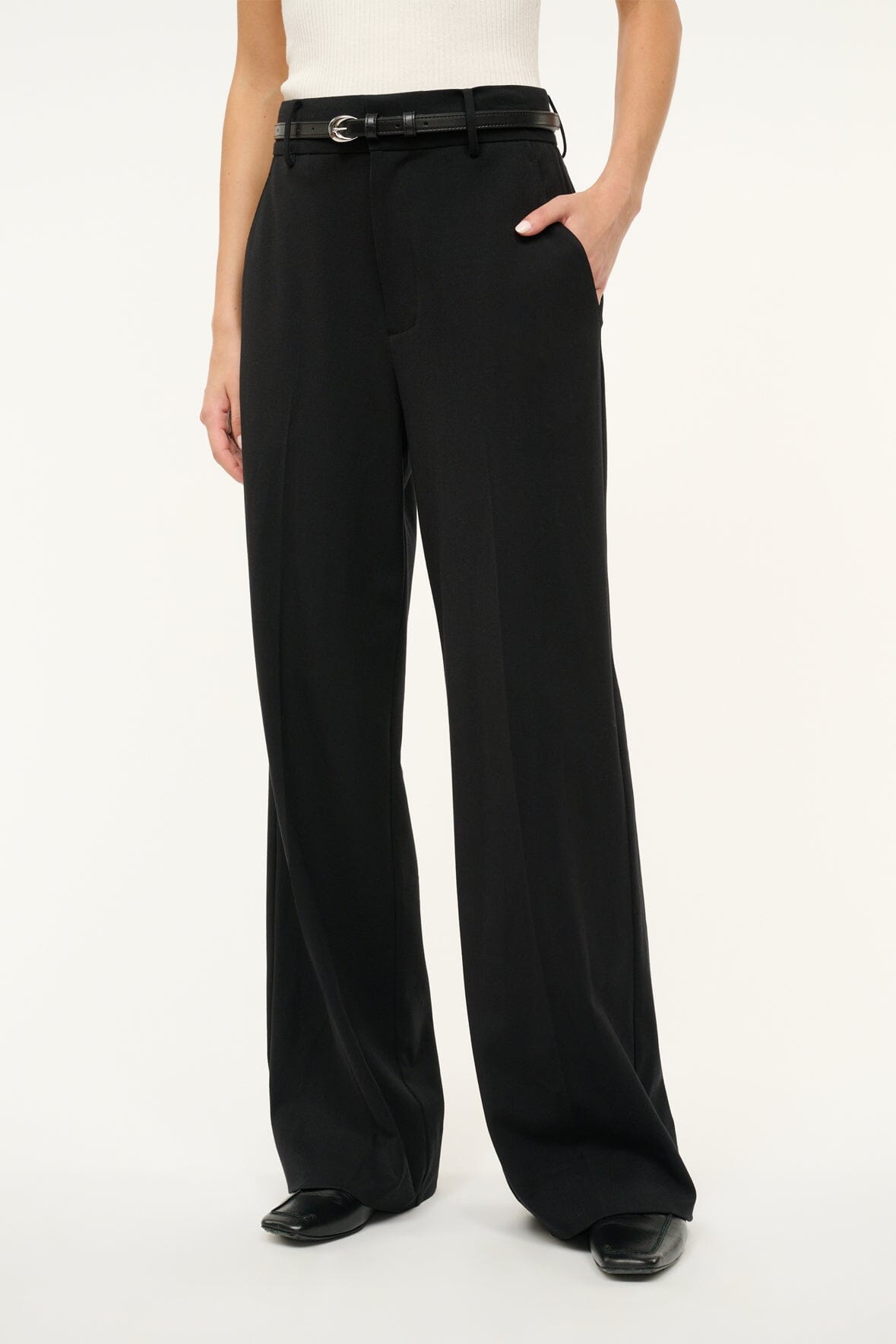 Black slim buckle belt with silver moon buckle, worn at waist