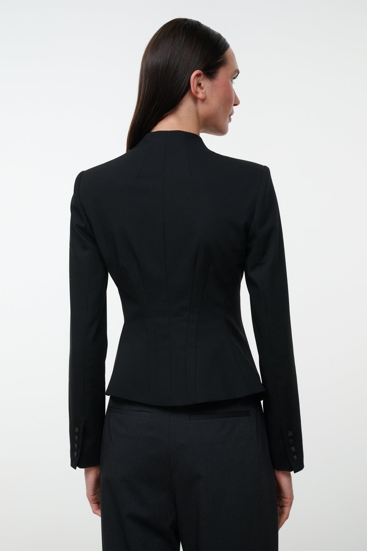 Black fitted jacket with high back and button details at center back