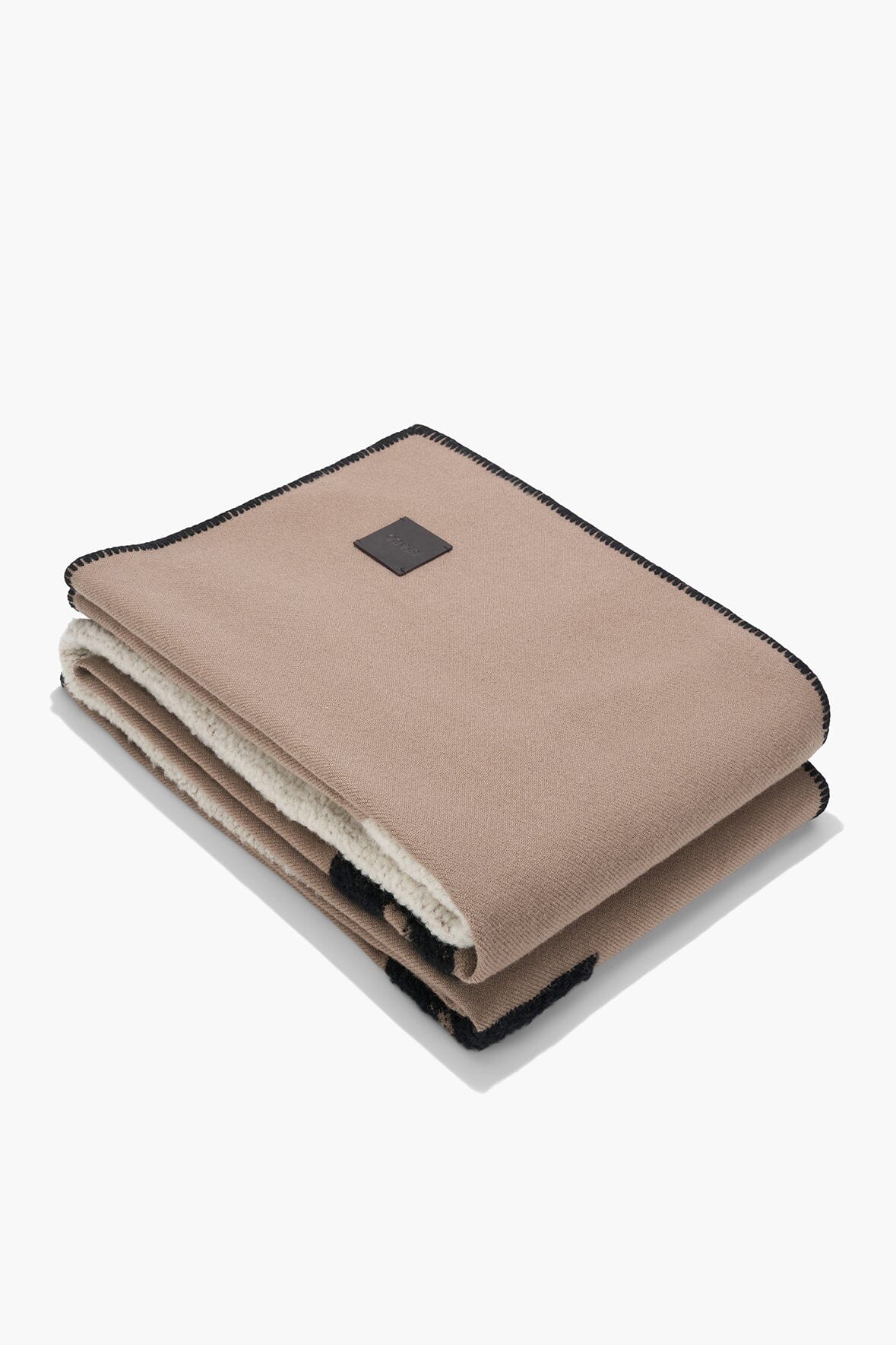 Truffle taupe sheep throw blanket folded, showing cream sherpa underside and edging