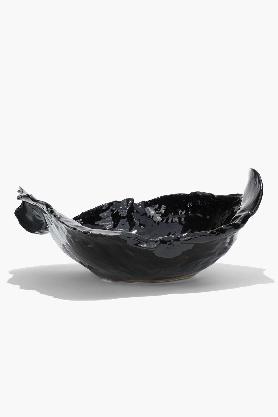 Black glossy wavy ceramic bowl with asymmetrical fluted edges