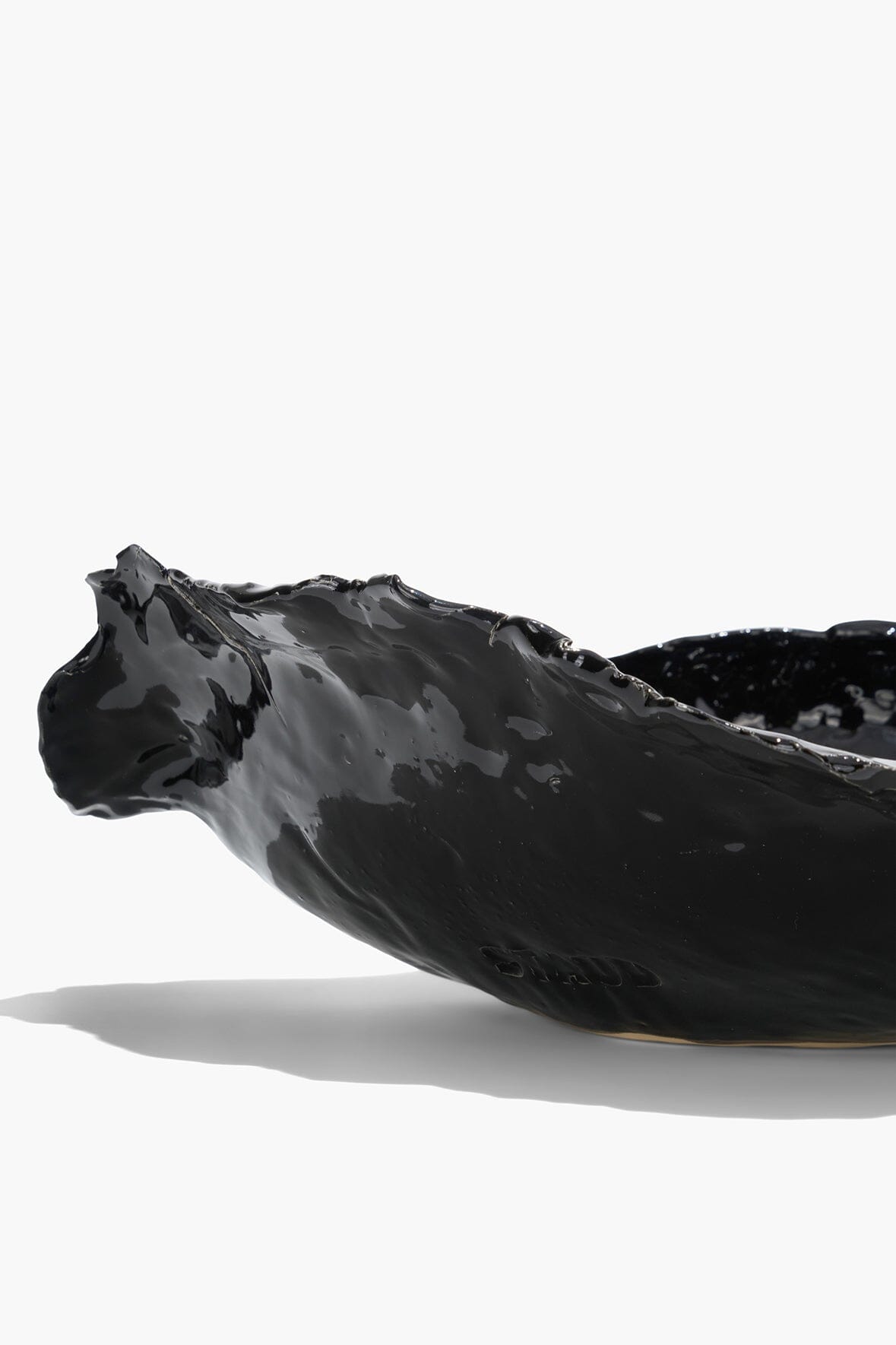 Black glazed wavy ceramic bowl with glossy wavy surface
