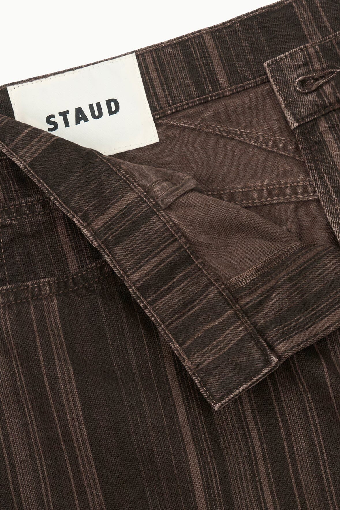 Dark espresso-striped relaxed jeans with STAUD label on the inner waistband