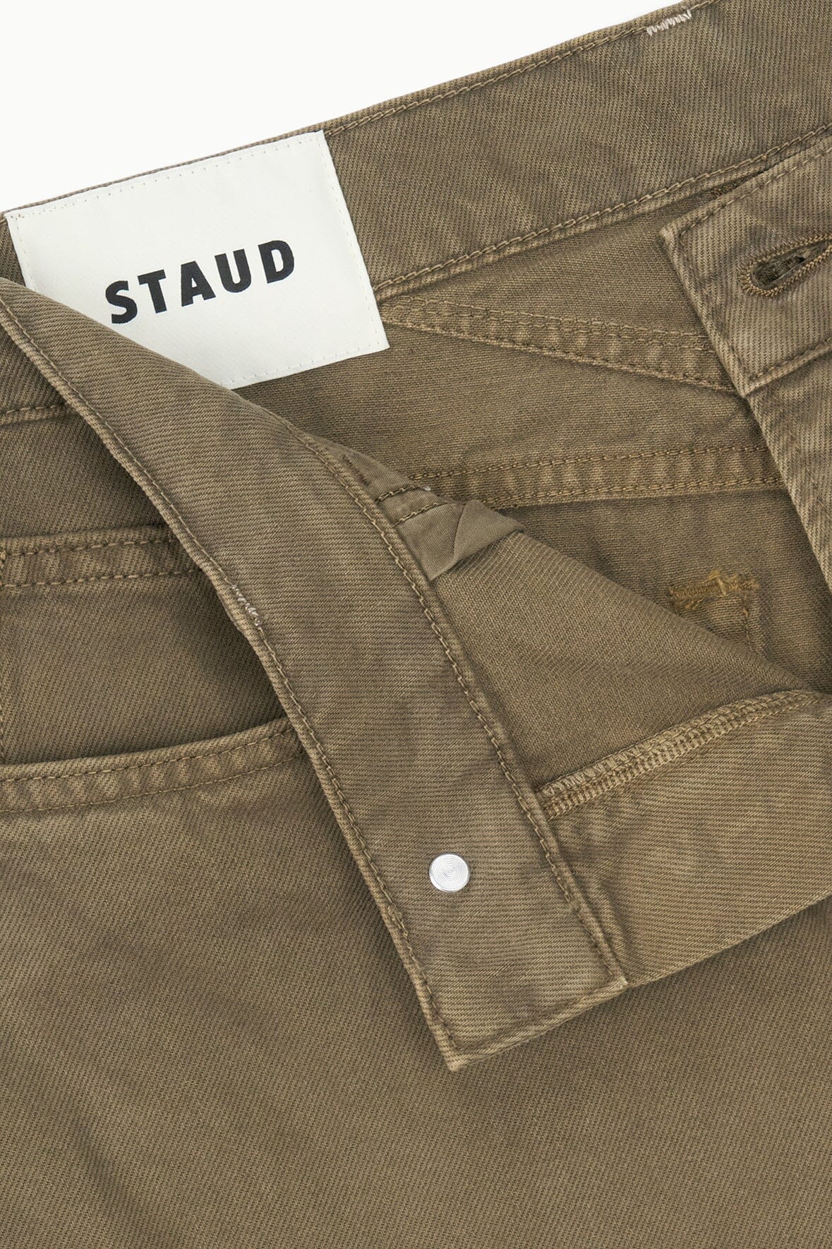 Greige relaxed jeans with STAUD logo label and hidden button closure