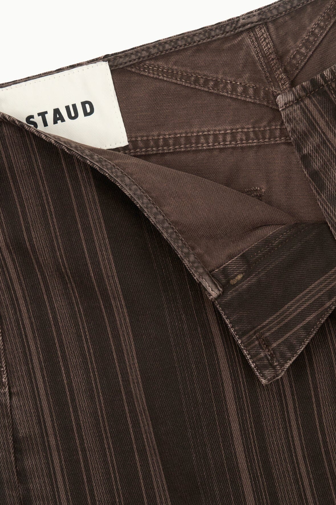 Dark brown pinstripe jeans interior with brand label and pocket seam detail