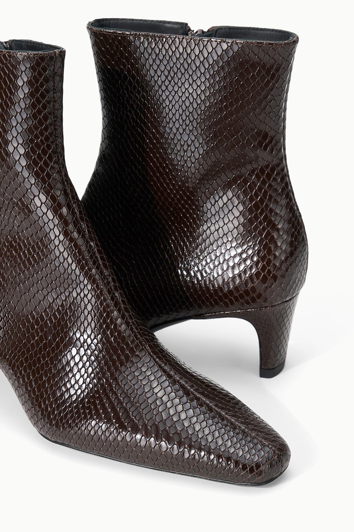 Espresso brown snake-textured ankle boot pair with mid block heel and curved toe