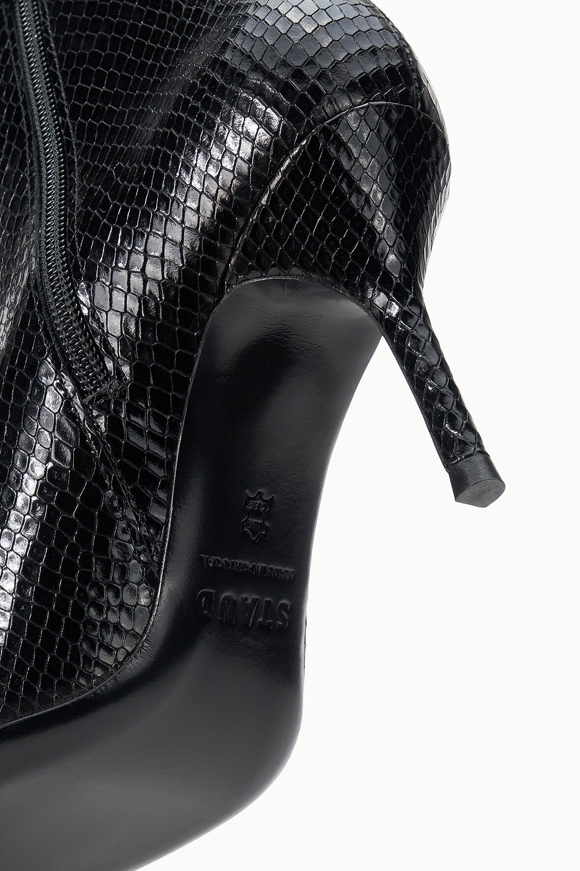 Black snake-print ankle boot close-up of side zipper and pointed toe