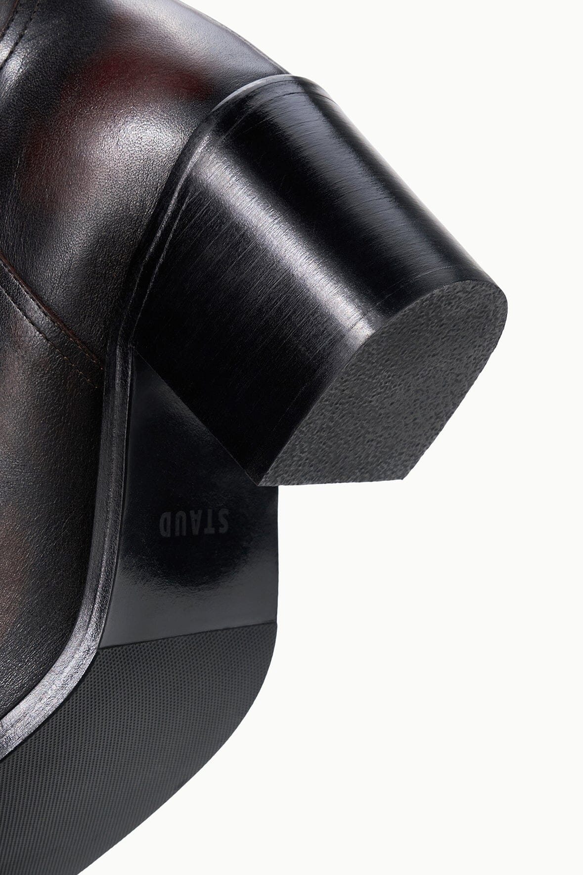 Close-up of dark leather boot heel and tread sole with padded edge
