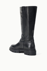 Black tall leather boot with rounded toe and chunky tread sole