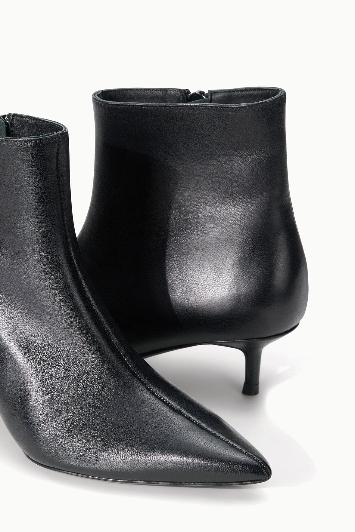 Pair of black ankle boots with pointed toe and slim kitten heel