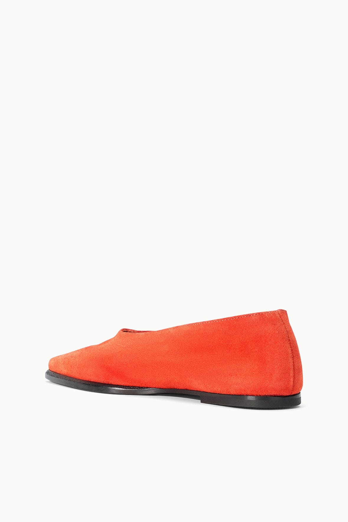 Orange suede flat slip-on shoe with low profile black sole