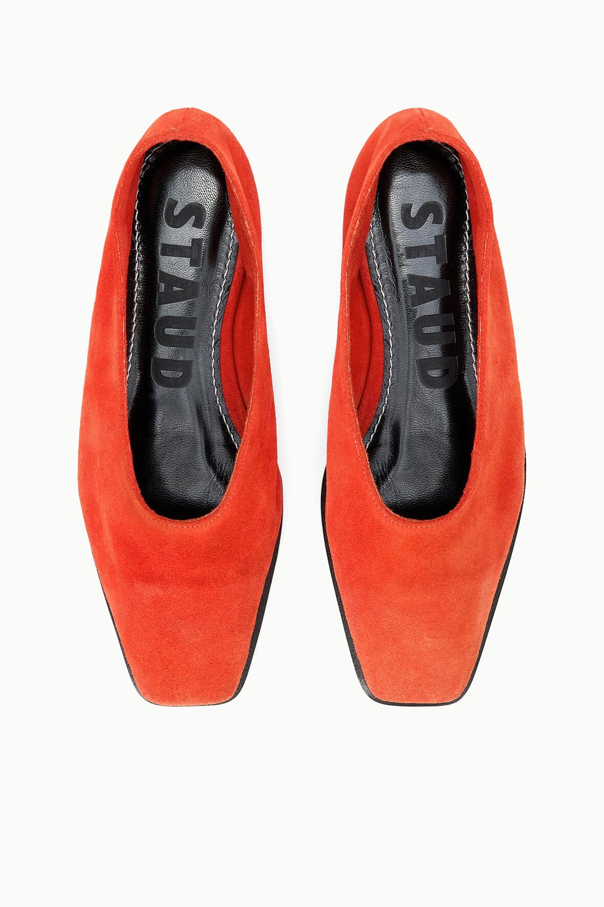 Orange suede flat slip-on shoes, top view showing interior lining