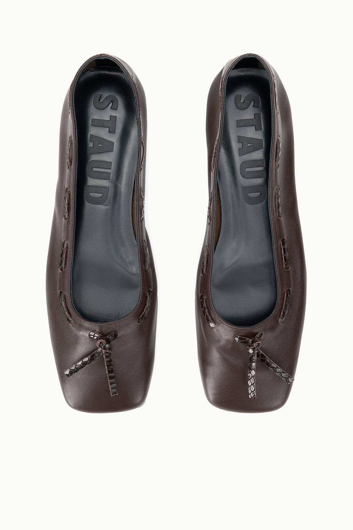 Espresso brown ballet flats with interior logo and bow detail, front view.