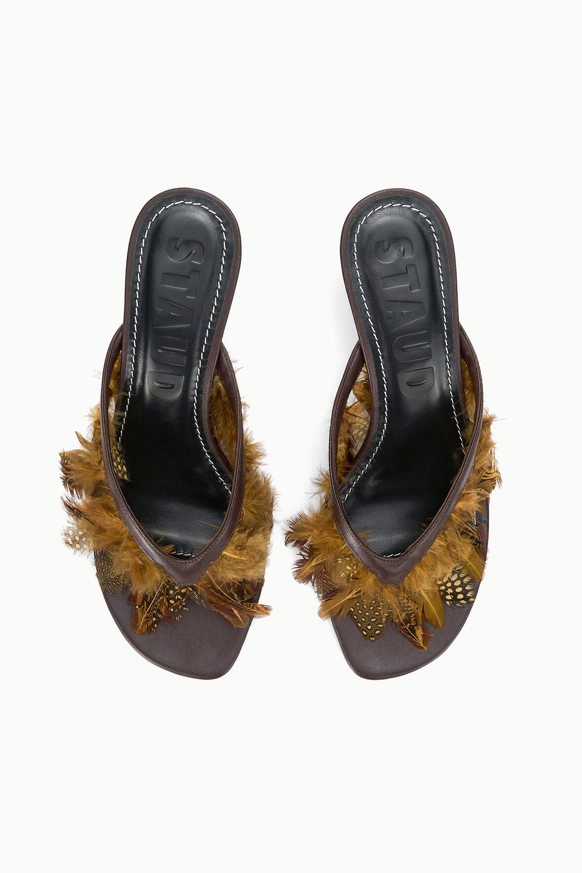 Pair of espresso brown mules with faux-fur fringe and stitched leather lining