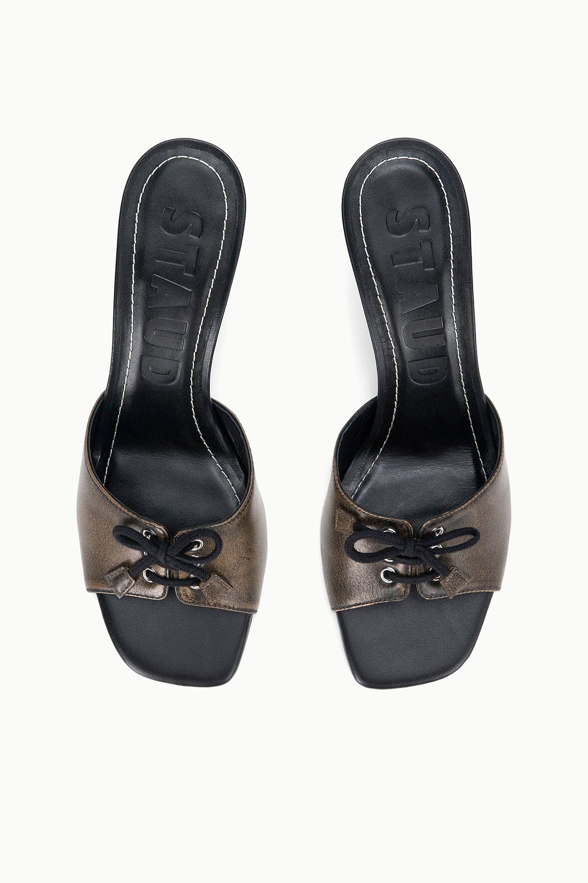 Pair of black distressed mule heels with lace bow at the front