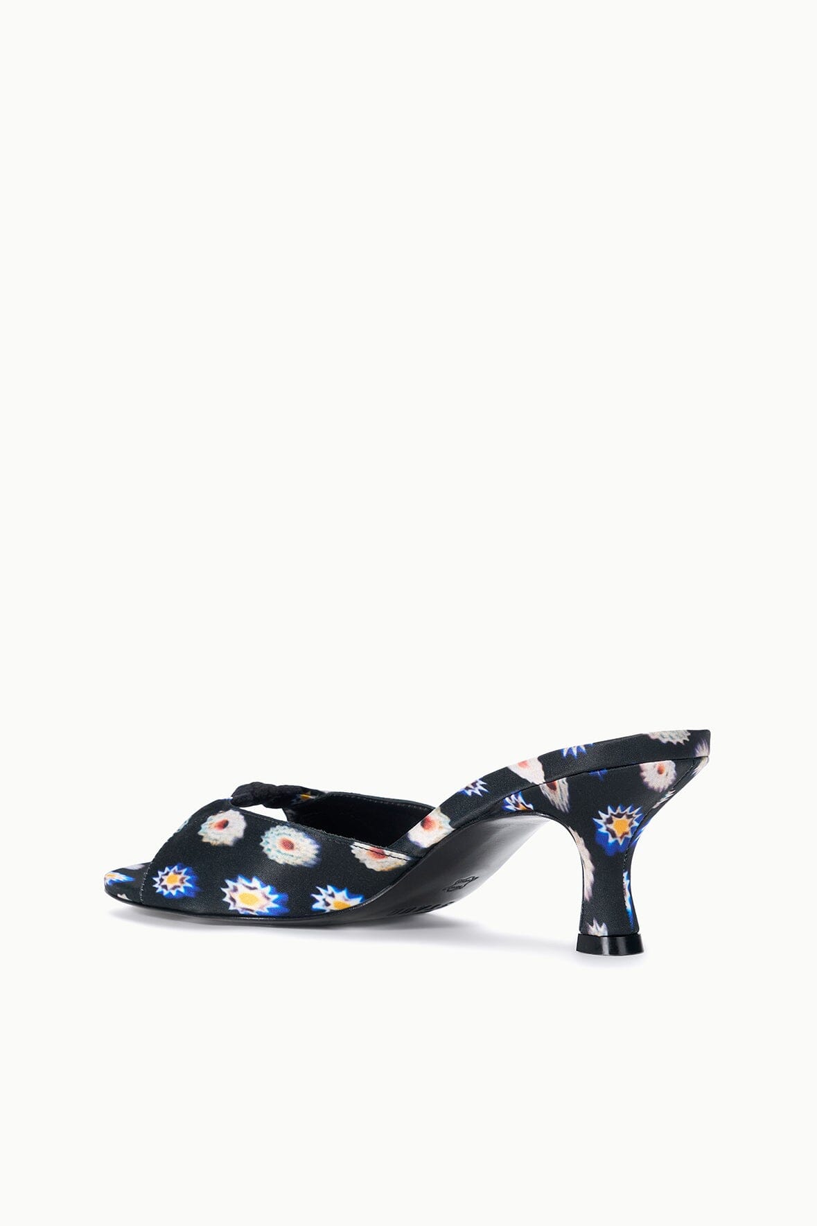 Black floral mule slide with low kitten heel, open back and patterned upper