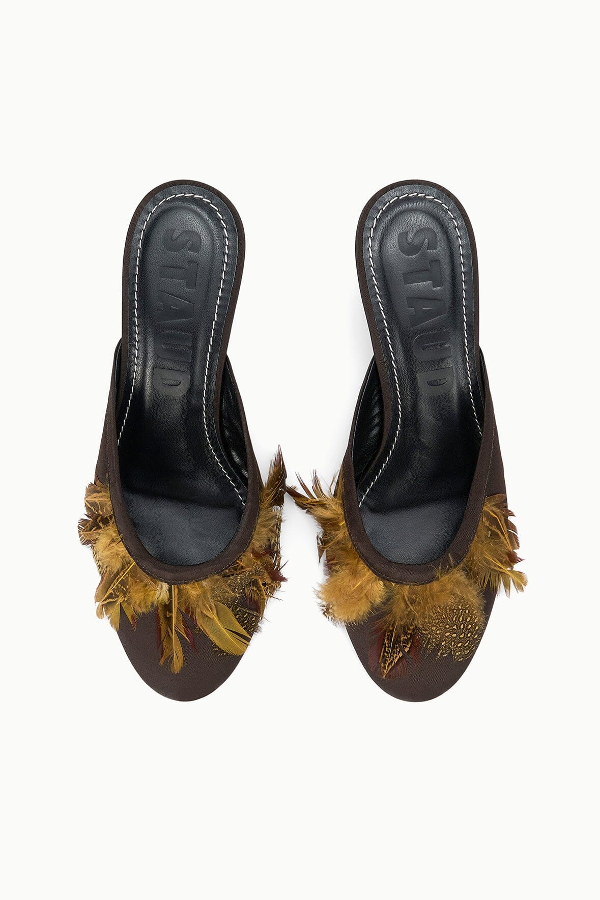 Pair of espresso brown mules with gold feather-trim and black interior lining