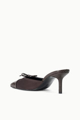 Espresso mule with snake-texture upper, lace front, and narrow stiletto heel.