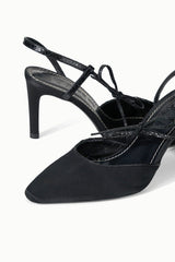 Black heeled slingback sandal close-up with bow ankle ties and strap details