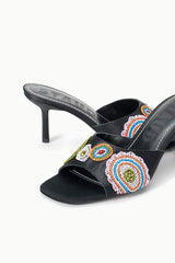Black heeled mule close-up: colorful bead mosaic embroidery on front strap